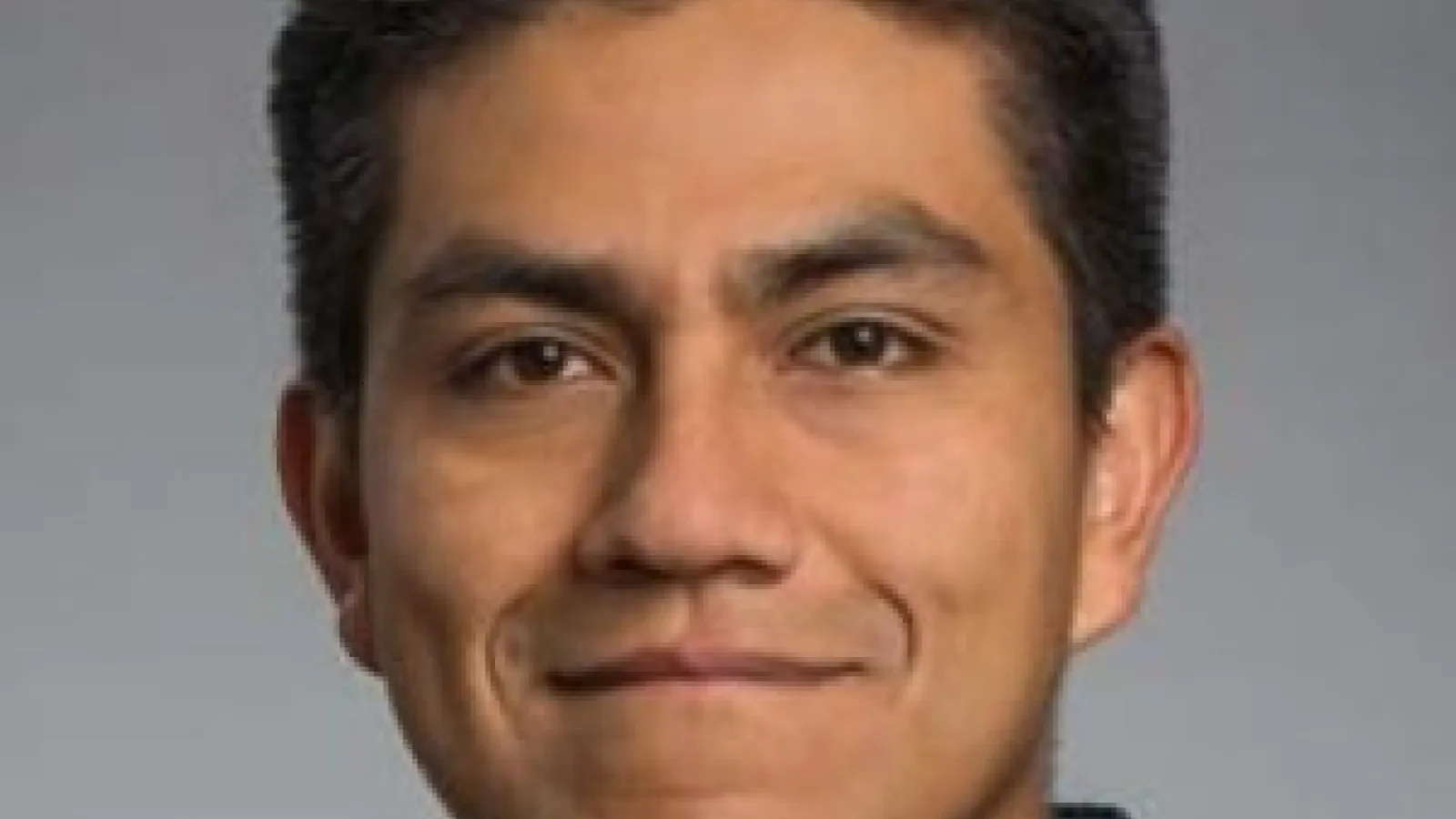 Headshot of Gabo in a plaid button down.