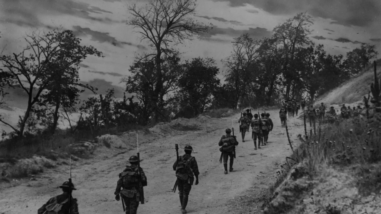 American soldiers walking up the road holding  bayonets at Mont St. Quentin
