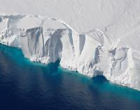 Getz Ice Shelf - white mountain of ice in clear blue water.