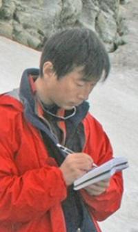 Yushin Ahn. Yushin Ahn writing research notes in the Arctic.