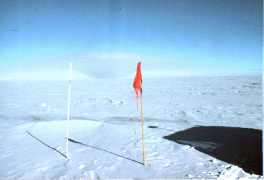 The South Pole standing straight from the ground in Antarctica.