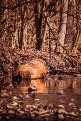 metal container in water way with corrosion