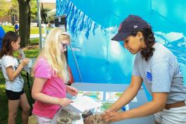 A scientist and a kid interacting at a park