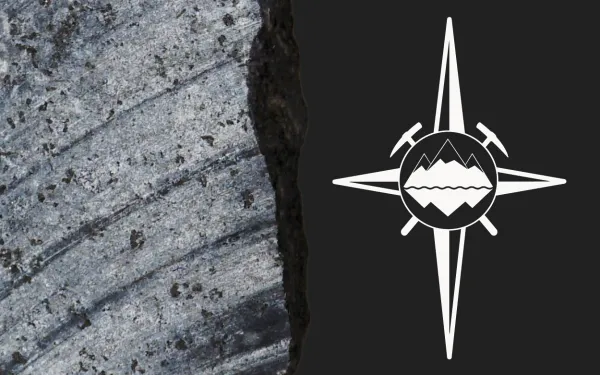Close-up of sedimentary rock showing distinct layers alongside a logo. The logo is a compass rose with a small set of mountains and two pickaxes at its center.