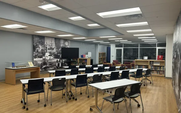 A room with a classroom layout facing a flatscreen TV. See caption for details.