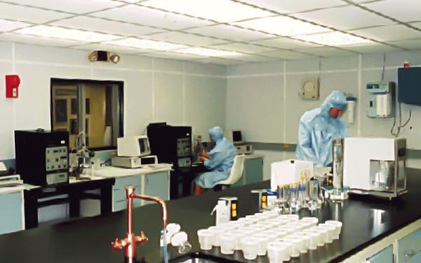 Ice core lab facility with two scientists in labratory clothing and various scientific instruments