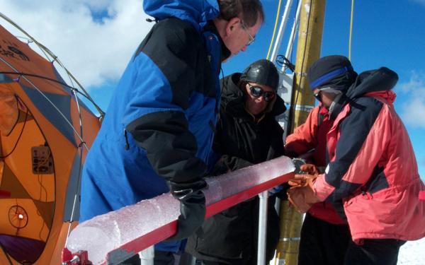 Dr. Lonnie Thompson and two other scientists hold an ice core at the summit of Quelccaya in 2003.