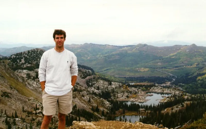 Rick Toracinta posing in front of mountains and water