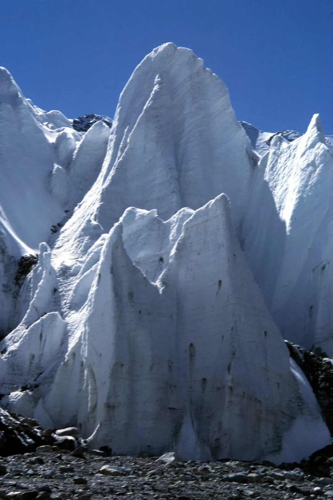 Large pieces of white ice on the dirt ground.
