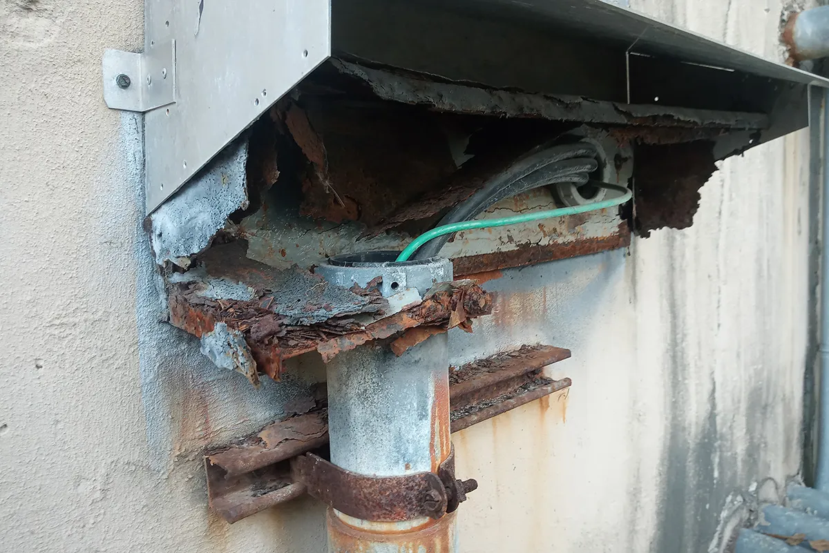 Corroded electrical box covered in rust.