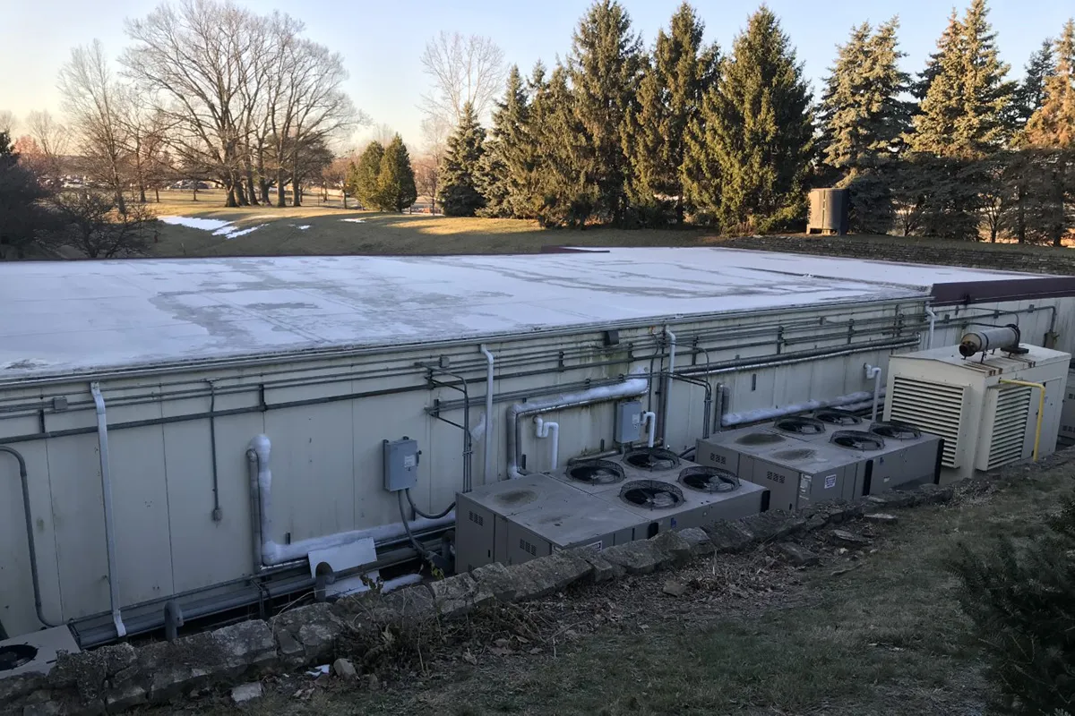 Refrigeration units are located outside and are very outdated.