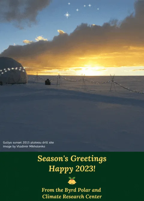 image caption on bottom left says Guluya sunset 2015 plateau drill site  image by Vladimir Mikhalenko with a domed tent and rope hanging from stakes with colorful twinkling lights on it and dome with a yellow blue sky and some starts with a snowy vista wishing Seasons greeting under image with gold lettering and bell with holly from the Byrd Polar and Climate Research Center