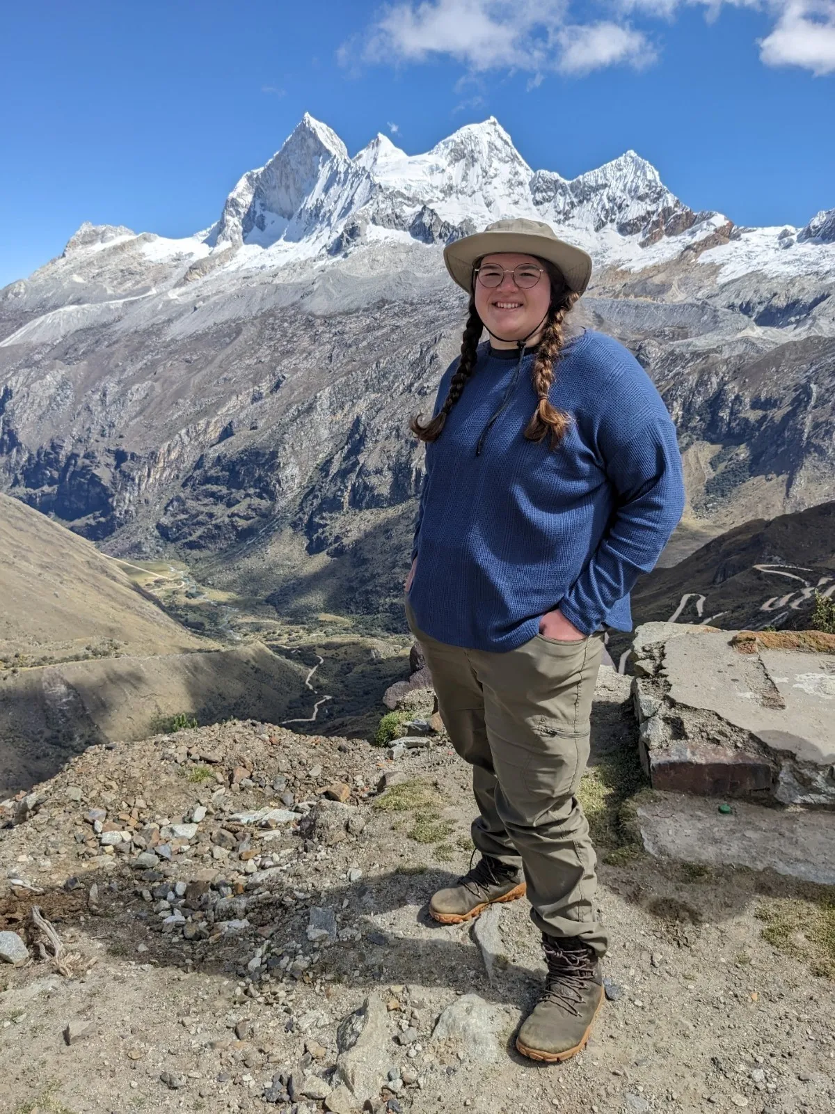 Elimy Mazan in the field with a backdrop of snow capped jagged mountains.