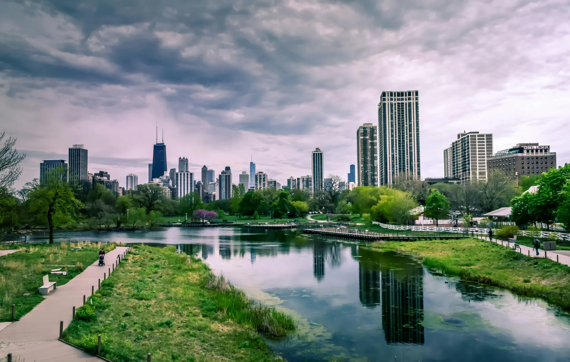 Green space in the city with a cityscape in the background.