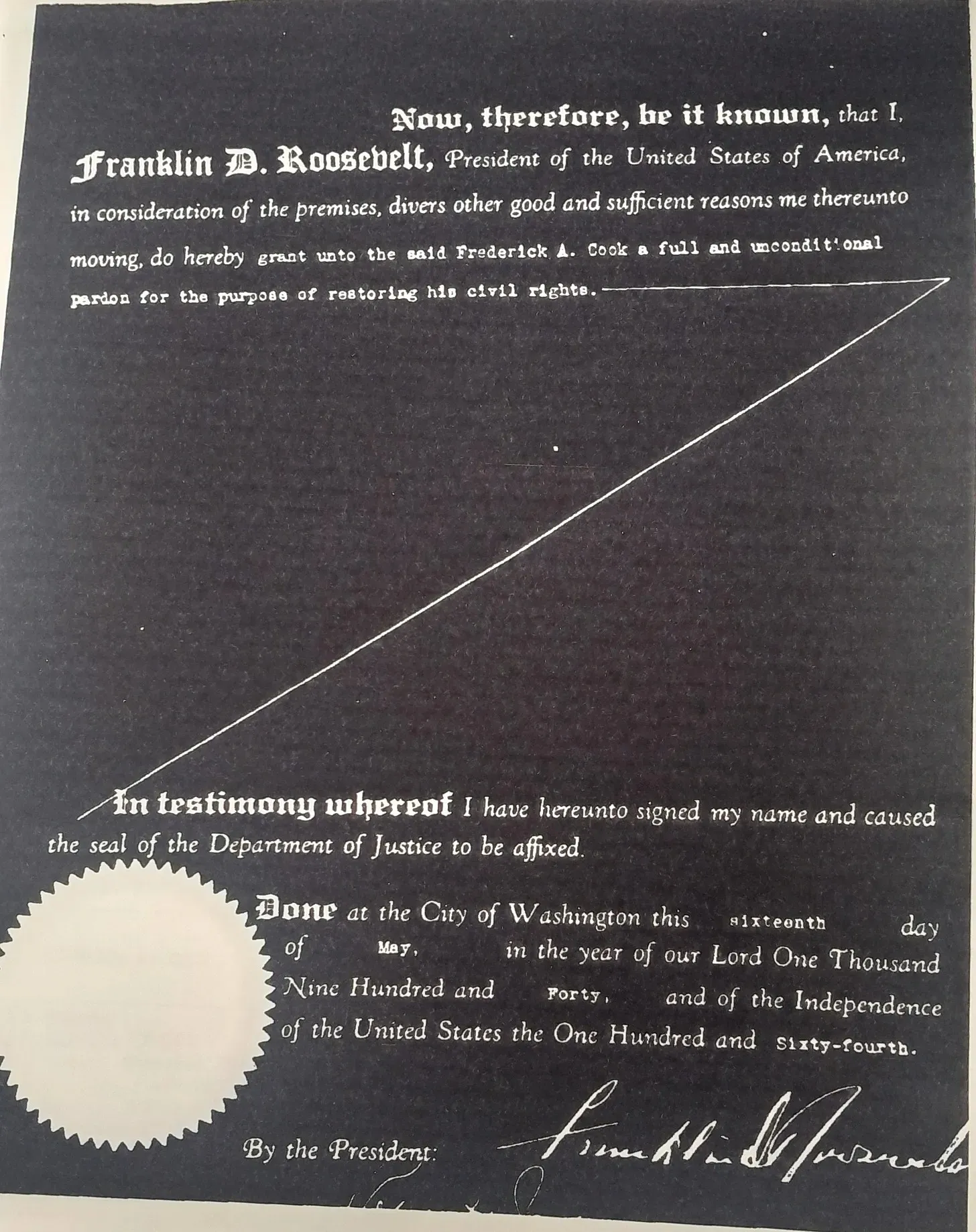 An old document in black and whiter with a golden seal at the bottom.