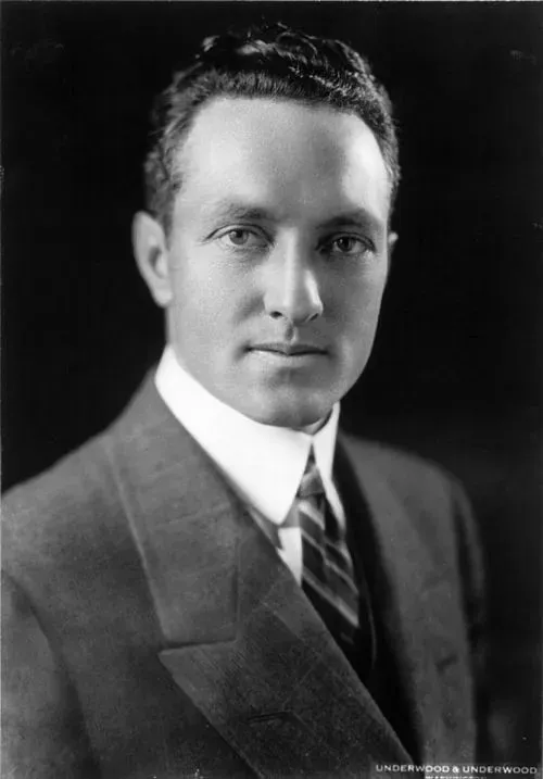Portrait of a man in a suit and tie, facing forward.