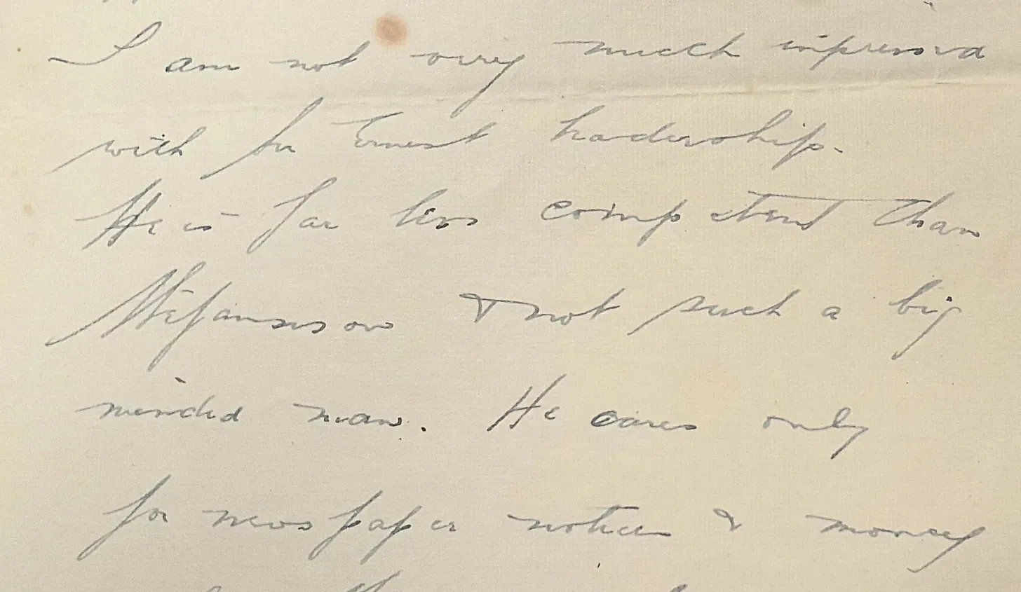 Close-up of a handwritten letter in cursive on aged paper.