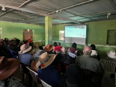 people in a community Hall watching a screening.