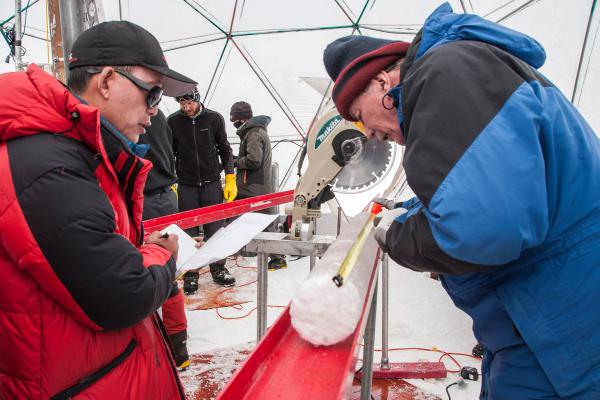 Dr. Yao and Dr. Thompson process an ice core.