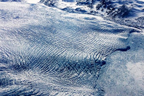 A glacier with a ripple like effect across the top of it