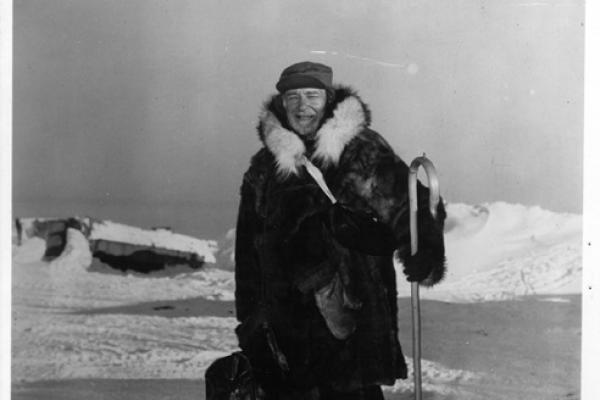 Black and white photo Hubert Wilkins standing on Ice in a thick winter coat 