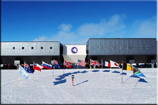 South Pole with flags and station in background