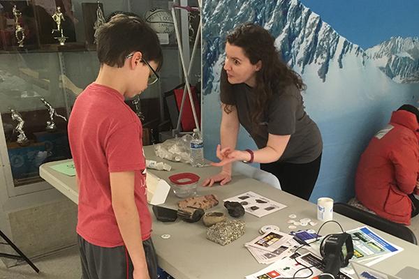 Stacy Porter working with a young boy at a table 