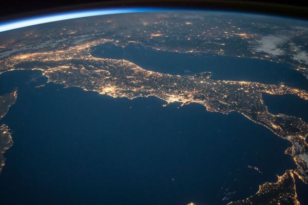 Photo of Italy from Space. The lights on the ground are displayed in the photo