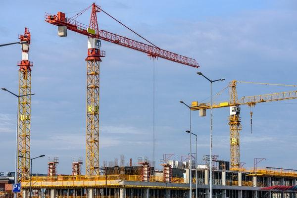 Top floor of building under construction and cranes