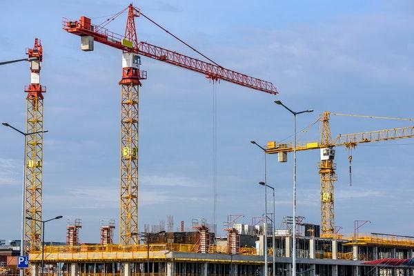 Top floor of building under construction and cranes