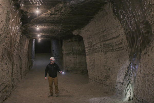 A member of the Permafrost Tunnel Research Facility stands in the permafrost tunnel