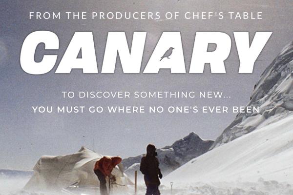 Poster : 2 men setting up a white tent next to solar panels in mountains surrounded by snow. Text  on image: From the producers of Chef's Table  Canary  to discover something new...you must go where no one's ever been  ACT4 Boardwalk Pictures REI Co-Op Studios