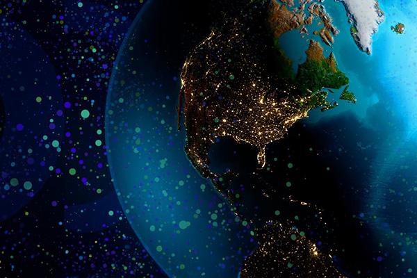 Earth against a dark background with points of light in blue and bright green