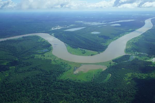 Aerial  of a large river winding in green valley