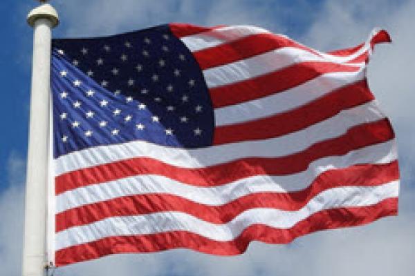 American flag attached to a pole blowing in the wind
