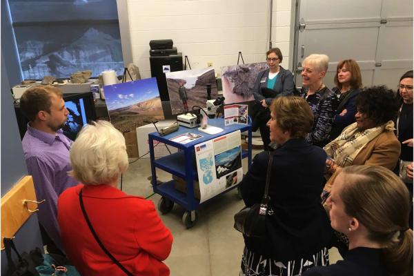 A group standing indoors for a tour.