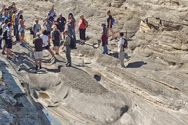 A group of people standing on a Rock formation