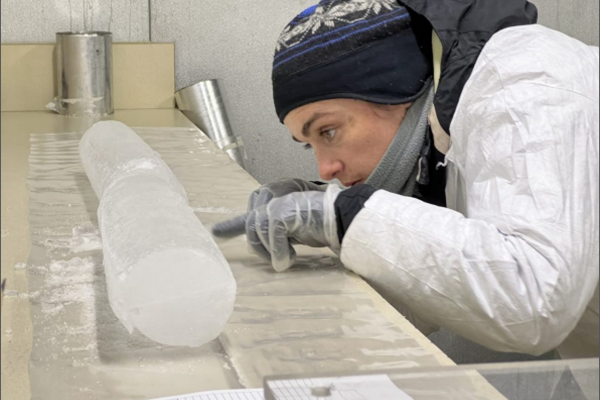 Researcher examining an ice core in the lab