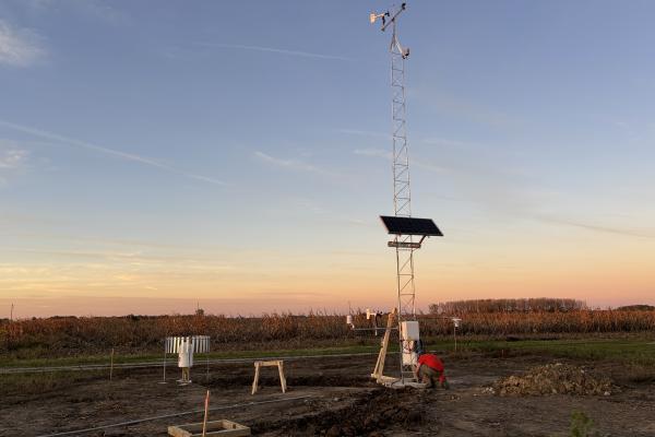 Ohio Mesonet Station on a farm with a sunset in the background