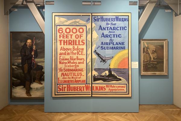 Large poster on teal wall. See caption for specifics.