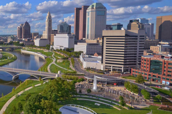 View of downtown buildings with river in foreground