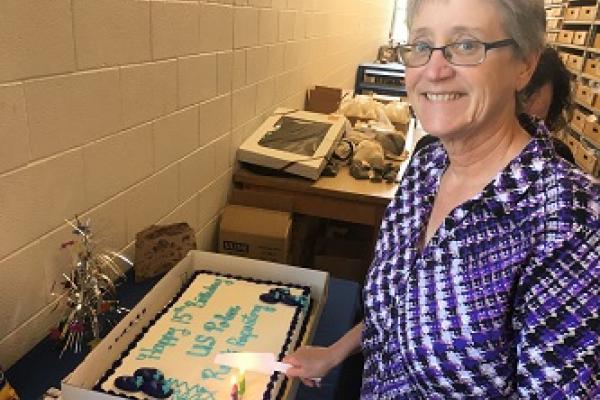 Anne Grunow cutting a birthday cake