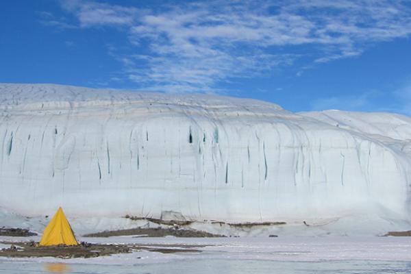 Tent Adjacent to Frozen Lake in Antarctica