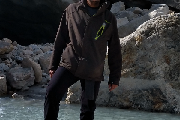 Saurabh Vijay Man in hiking gear standing on a rock