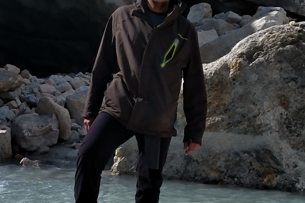 Man in hiking gear standing on a rock