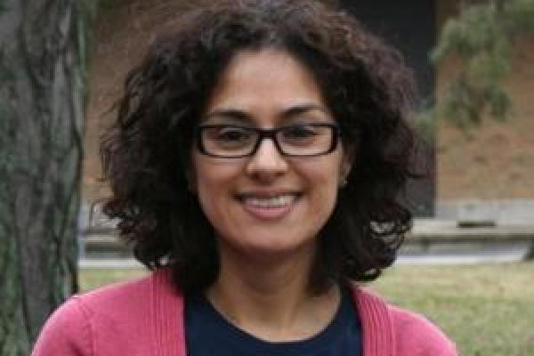 Woman with black hair and pink shirt