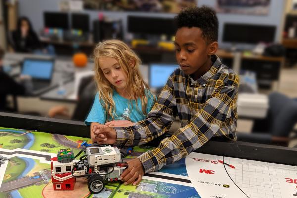 Lego League Teamwork Lego league teammates work on solving their latest challenge.