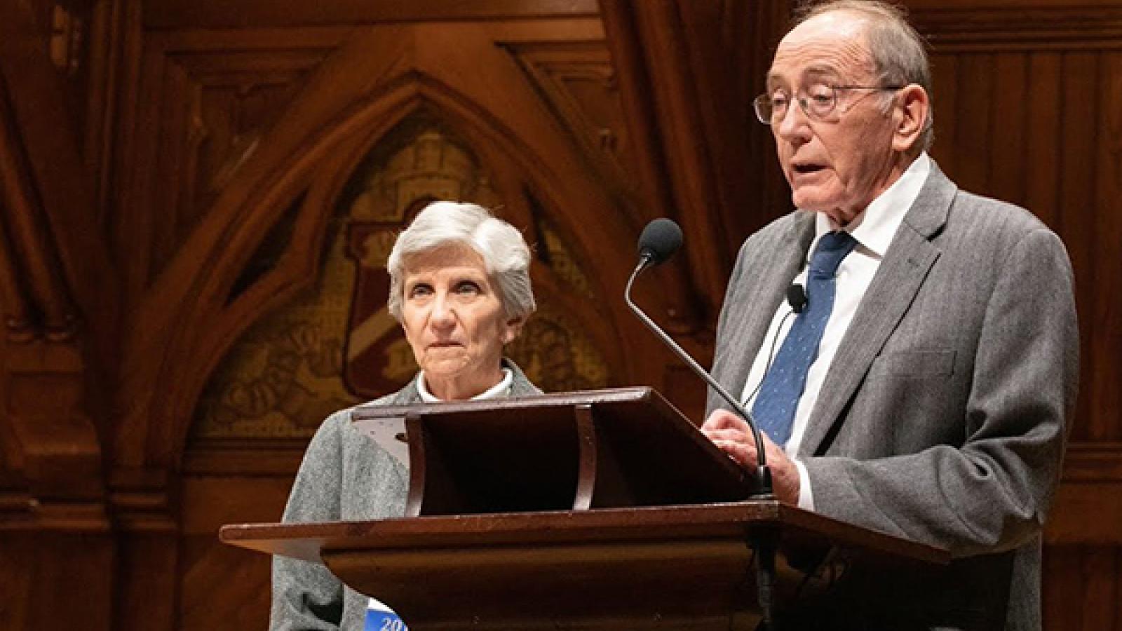 h Ellen Mosley-Thompson and Lonnie Thompson giving a presentation at a podium 