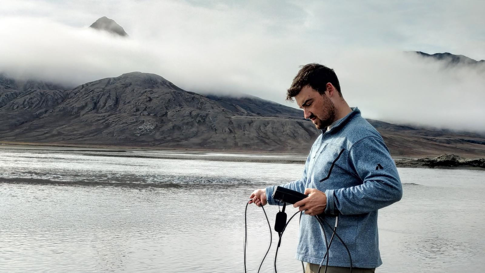 Collecting physicochemical data from Expedition River, Axel Heiberg Island, High Arctic of Canada