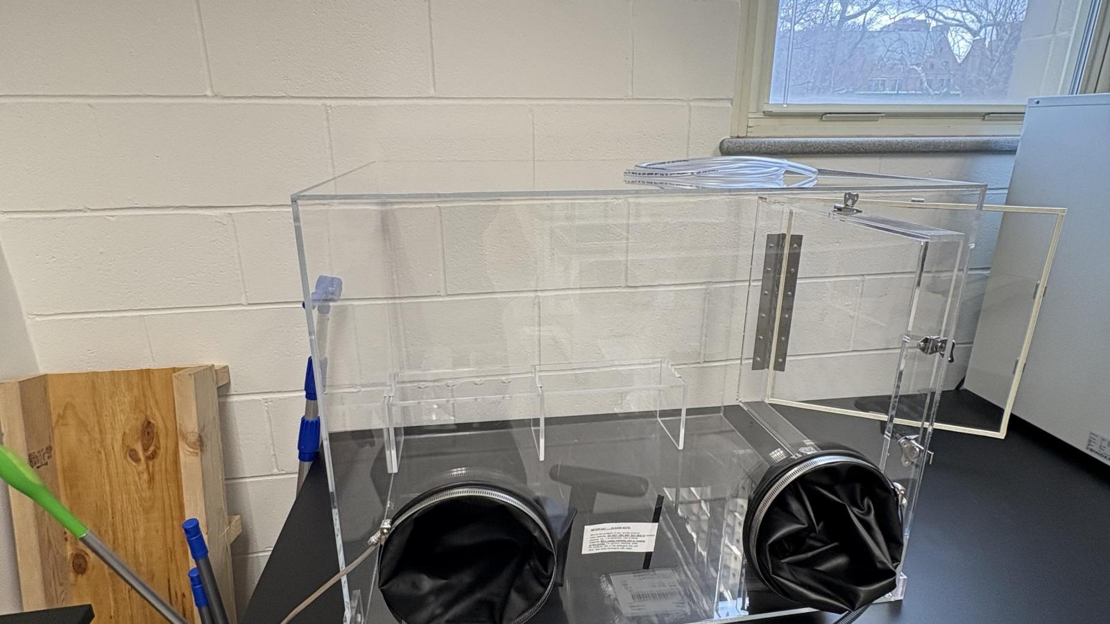 Enclosed small clear box with gloves attatched